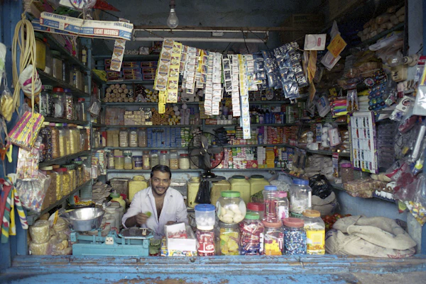 Indian store merchant managing cash flow and repayments