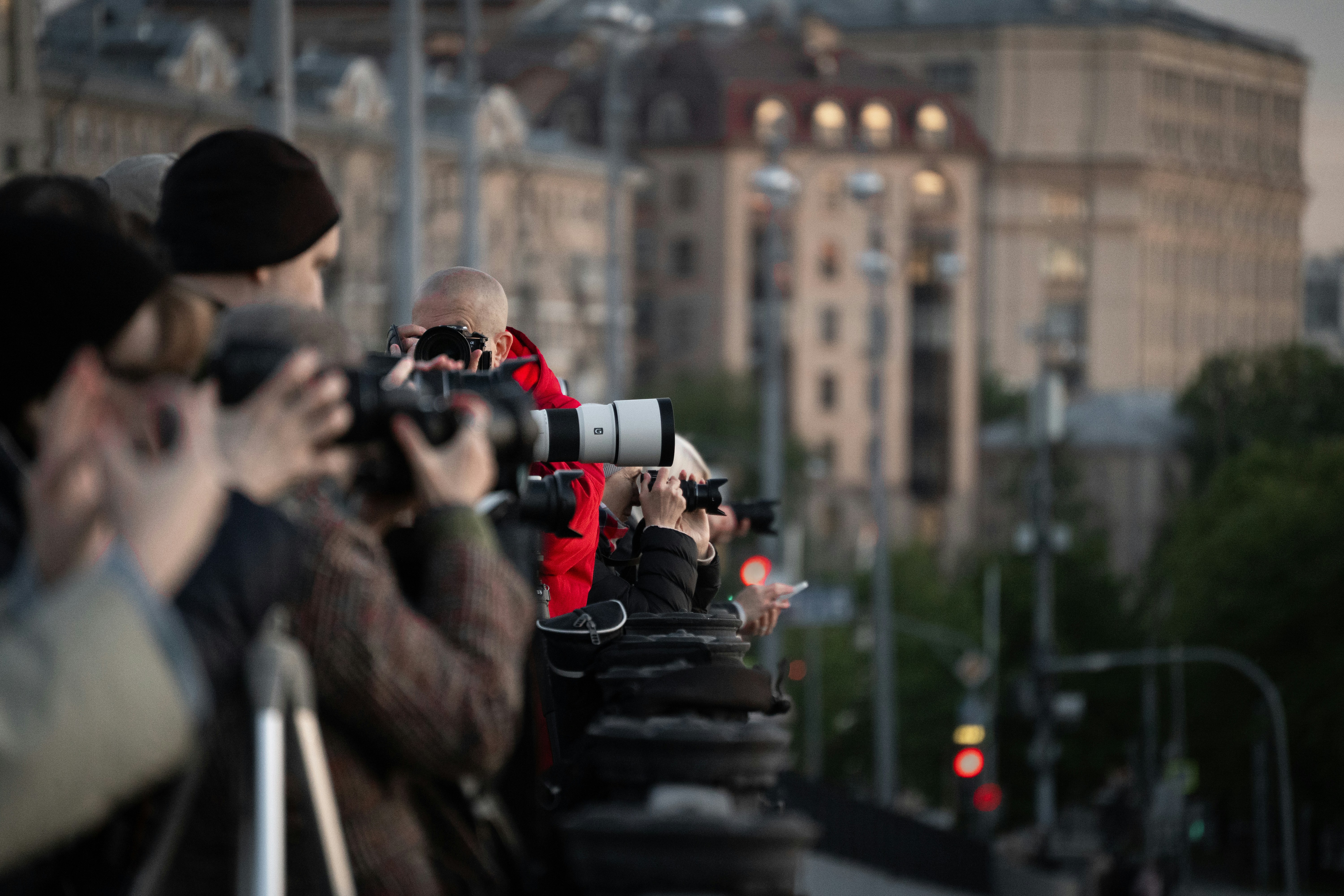 Photographers are taking pictures of a cityscape.