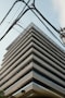 Building's angular architecture framed by power lines.