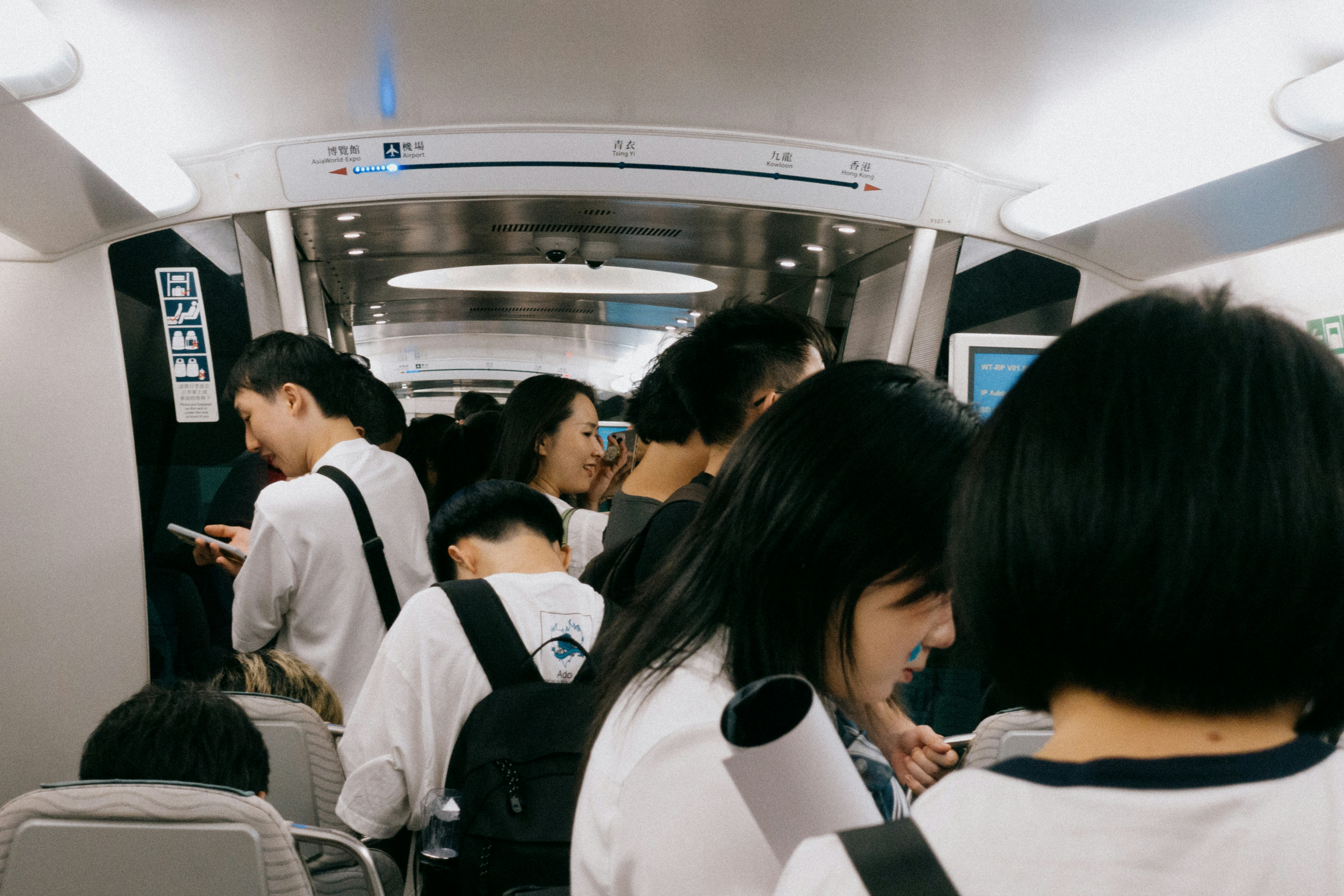 Passengers crowd a train car.