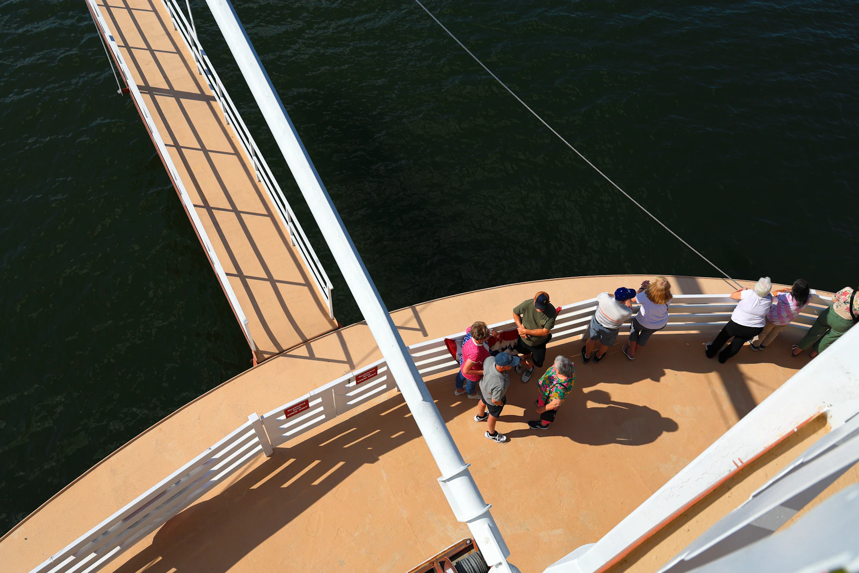 Travellers spending time together on the open deck of a ship
