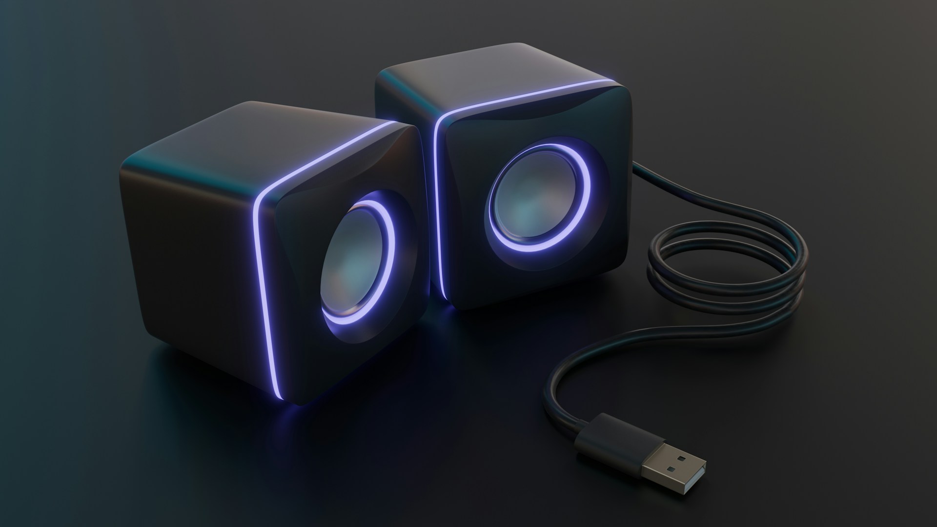 Modern speakers with glowing blue light.