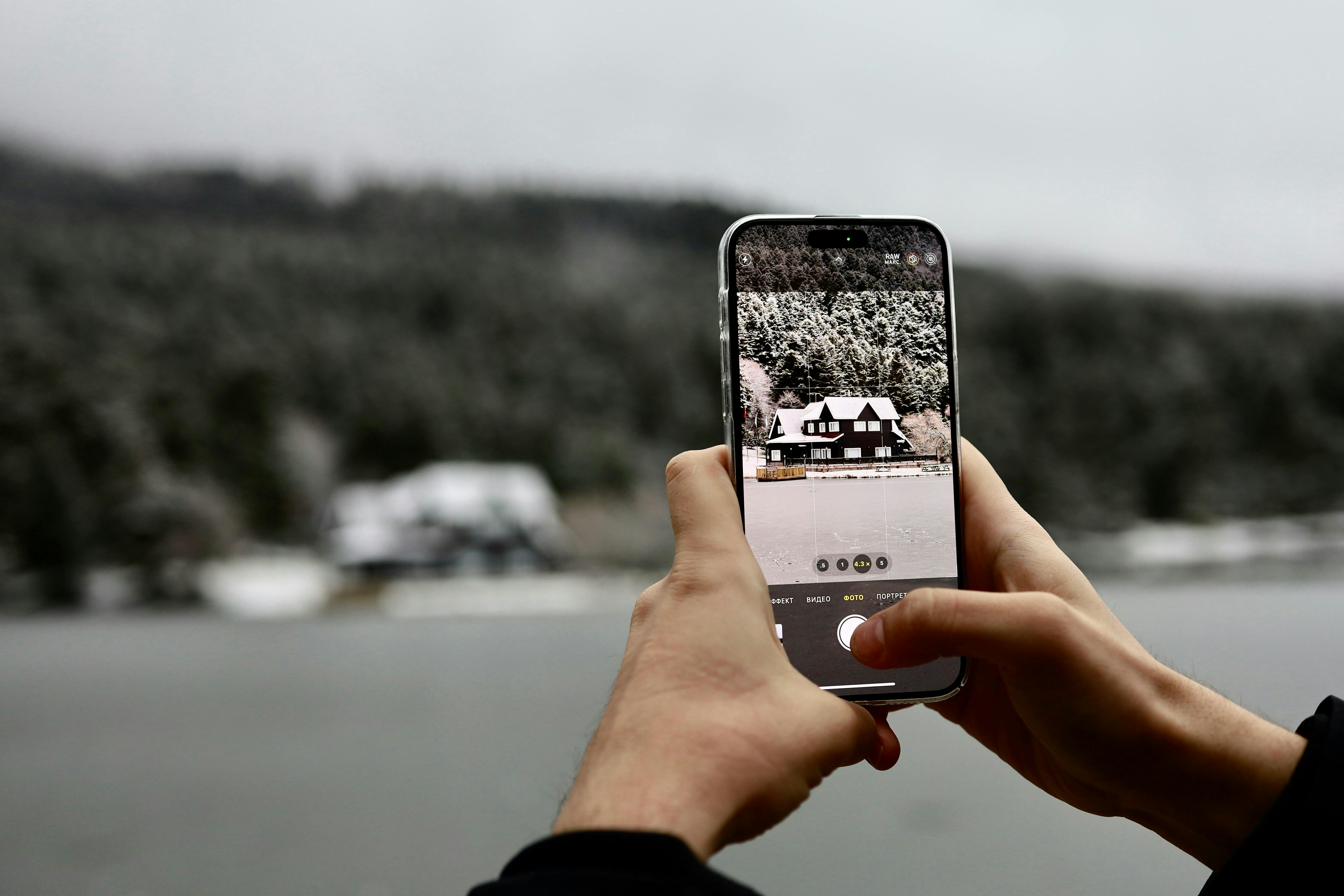 Taking a photo of a snowy landscape.