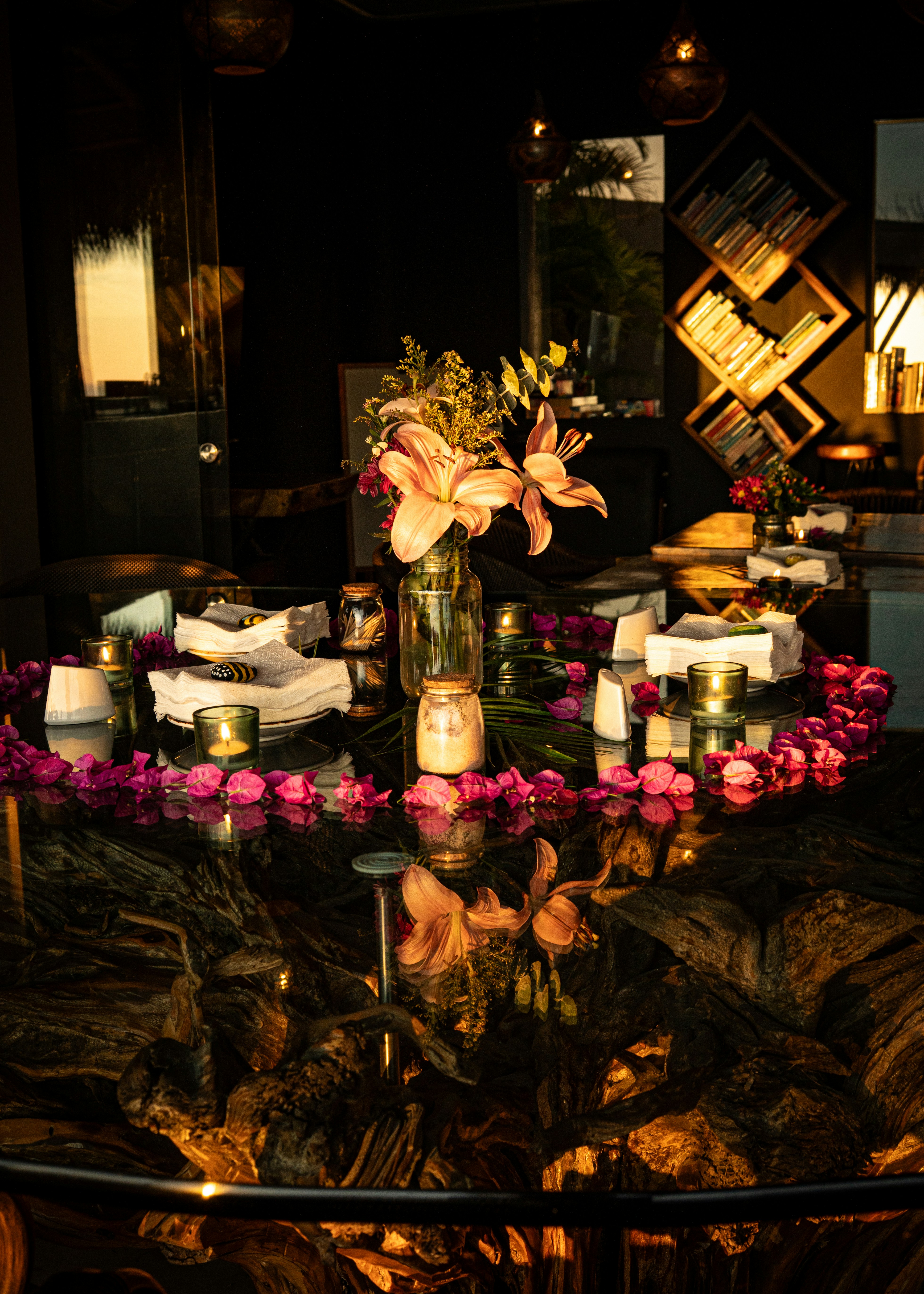 A table is decorated with flowers and candles.
