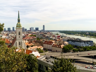 View of a city with church and river.