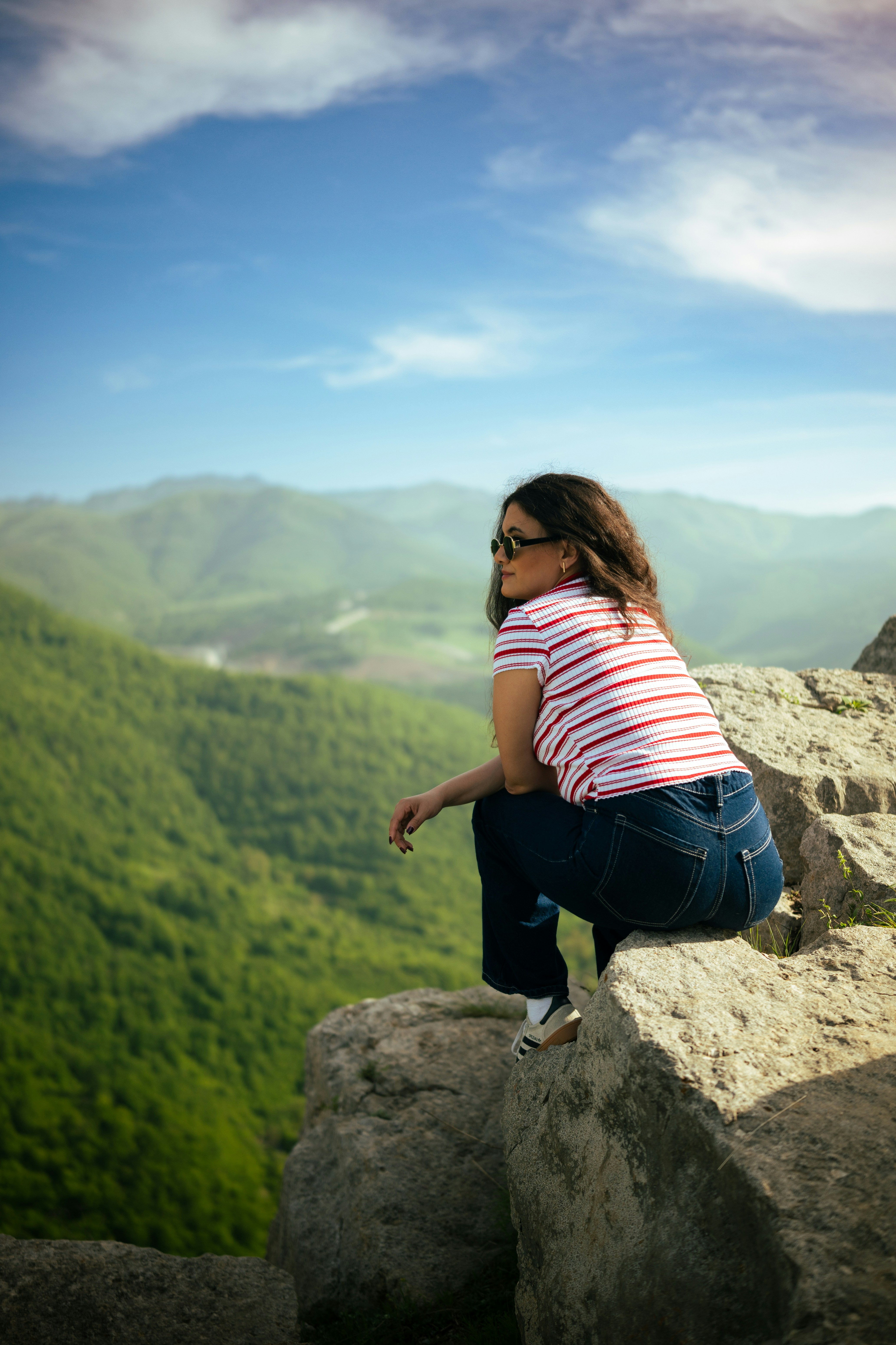 Woman enjoys the view from a mountaintop.