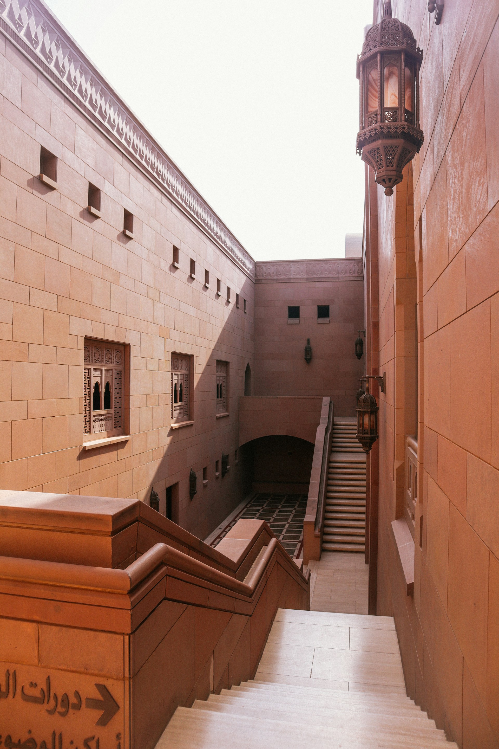 Stone steps lead to an architectural courtyard.