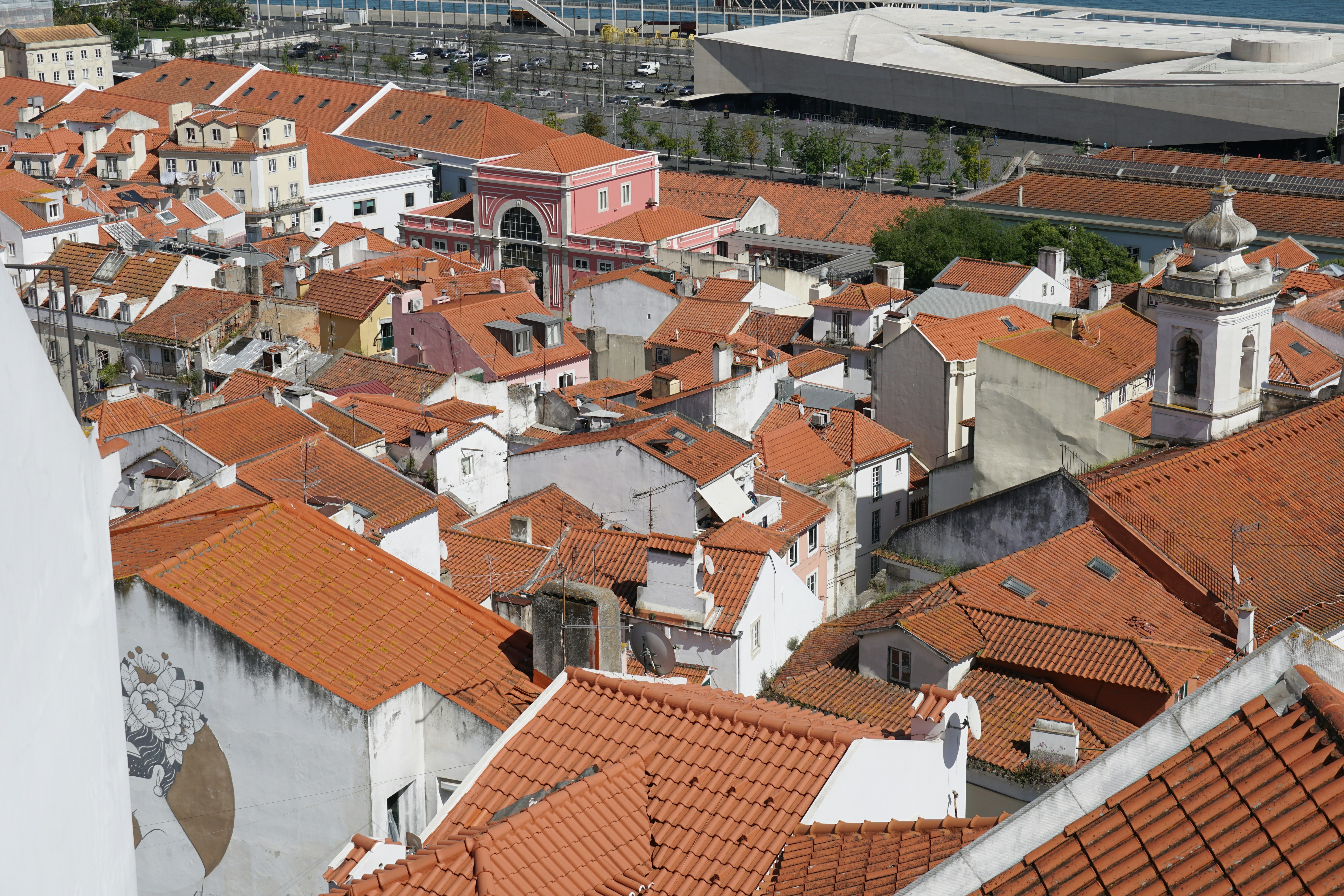 Aerial view of a city with many orange rooftops.