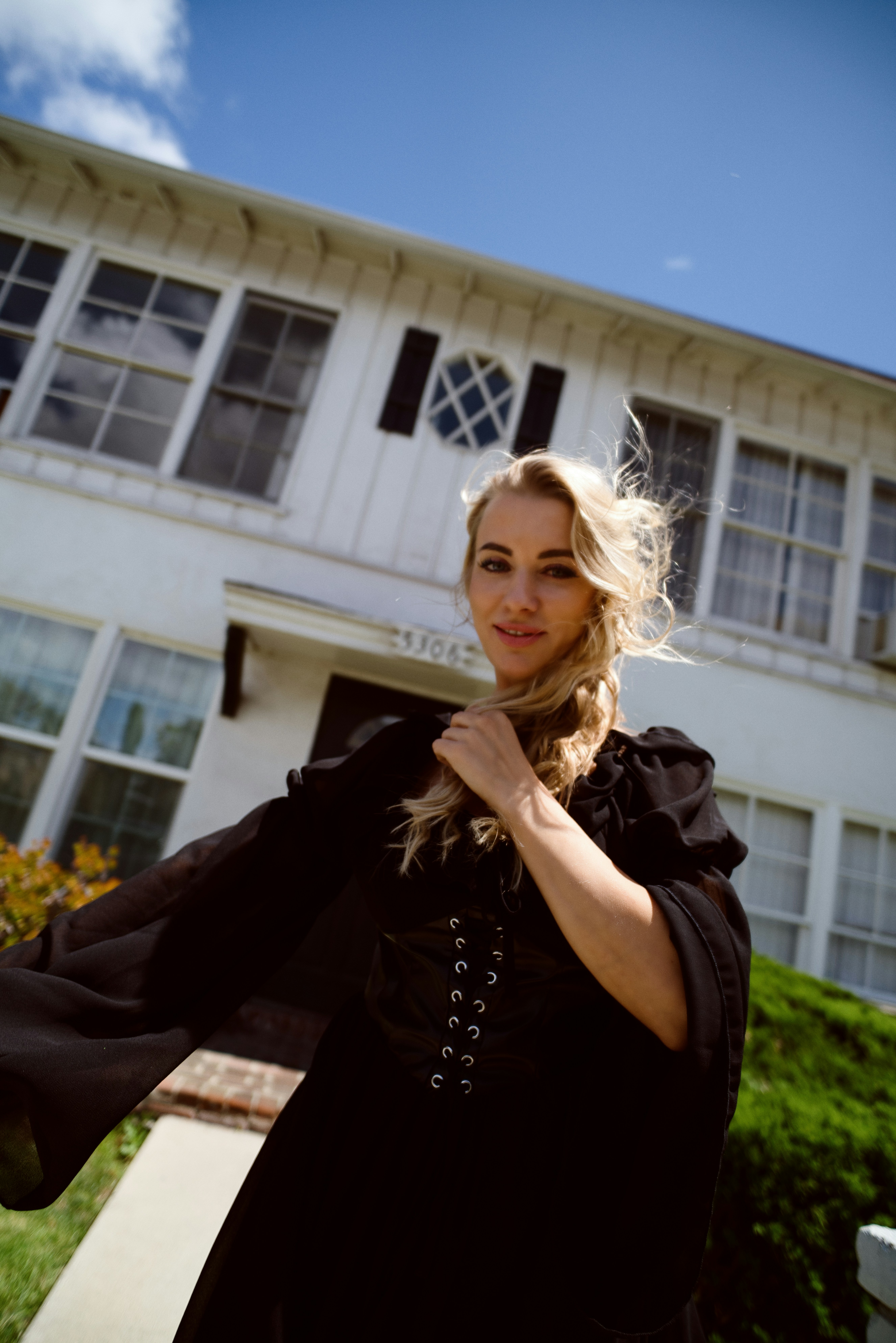 A woman poses in front of a house. photo – Free Model Image on Unsplash