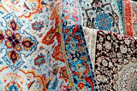 Colorful patterned rugs are on display.
