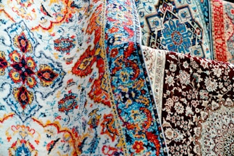 Colorful patterned rugs are on display.