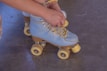 Someone is tying their roller skate laces.
