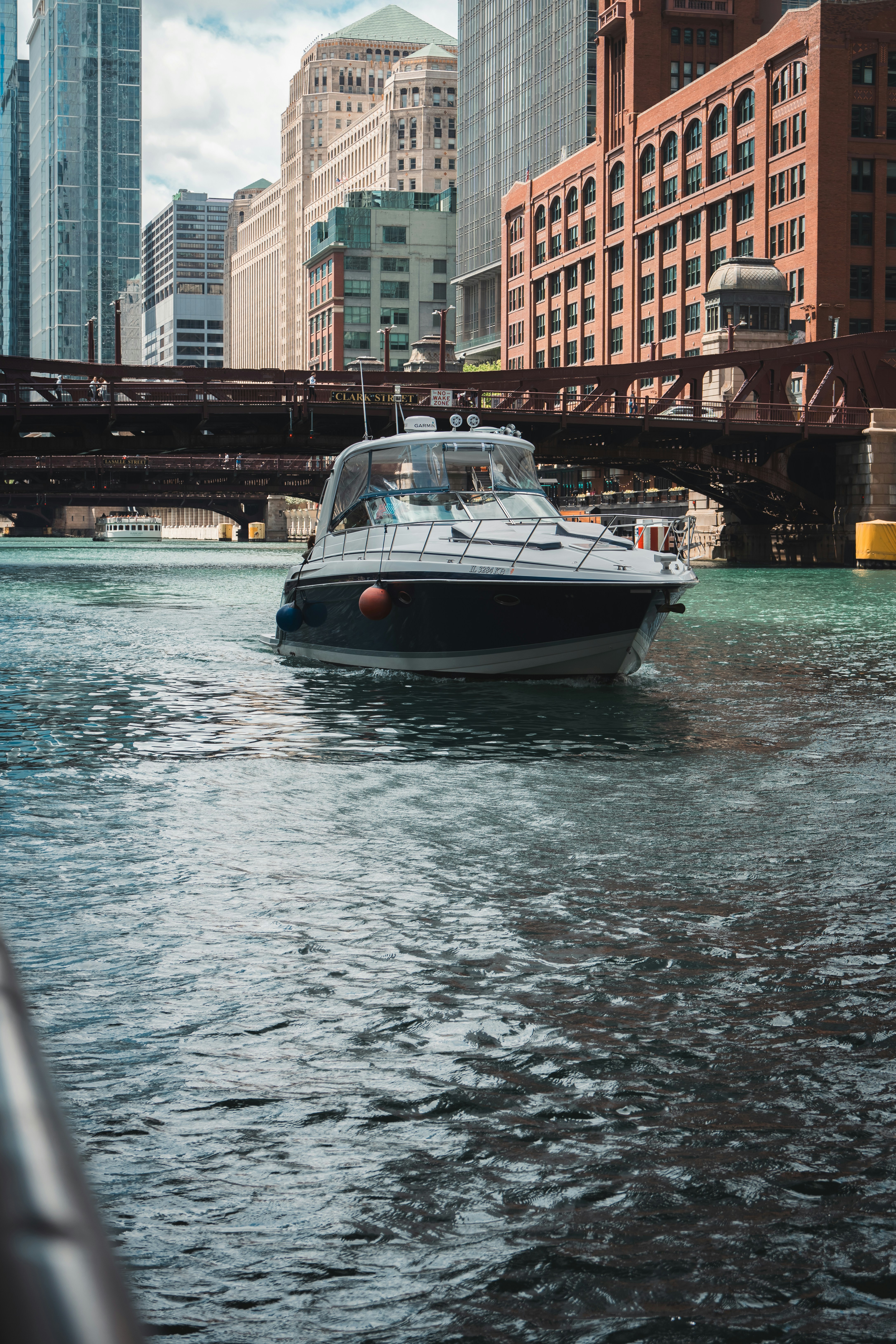 A boat cruises along a city river.