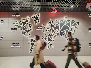 People walk past a glowing world map.
