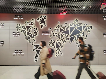 People walk past a glowing world map.