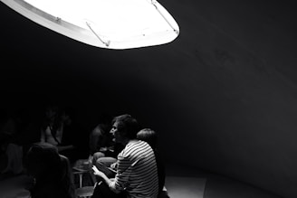 People are gathered in a dimly lit room.