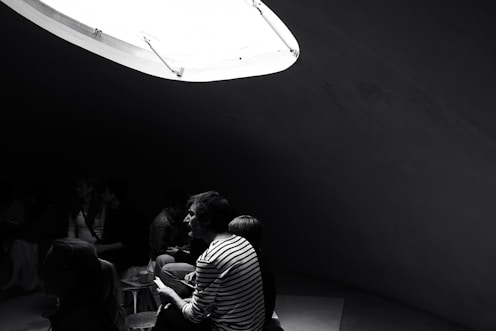 People are gathered in a dimly lit room.