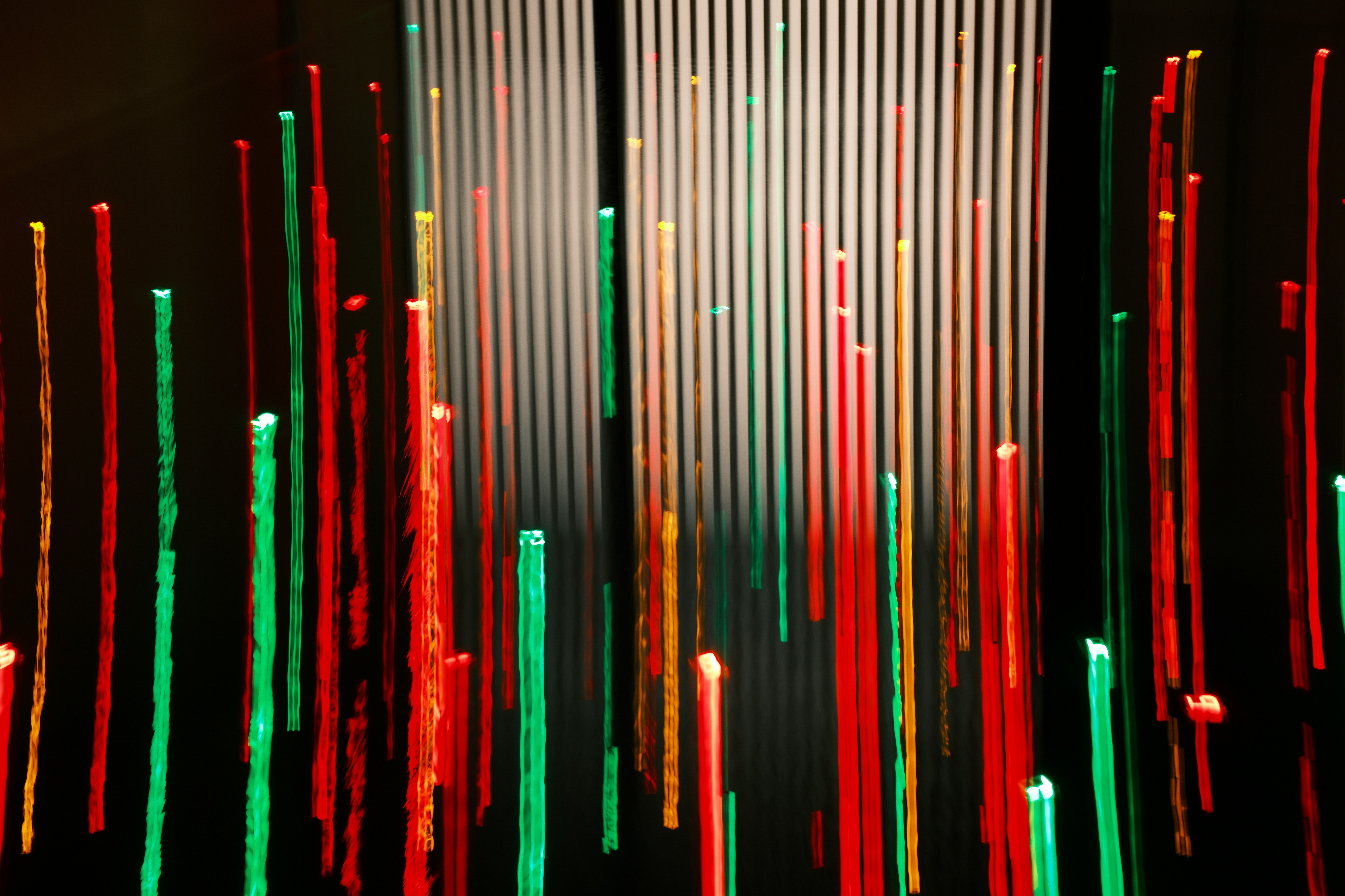 Red, green, and gold columns in abstract form.