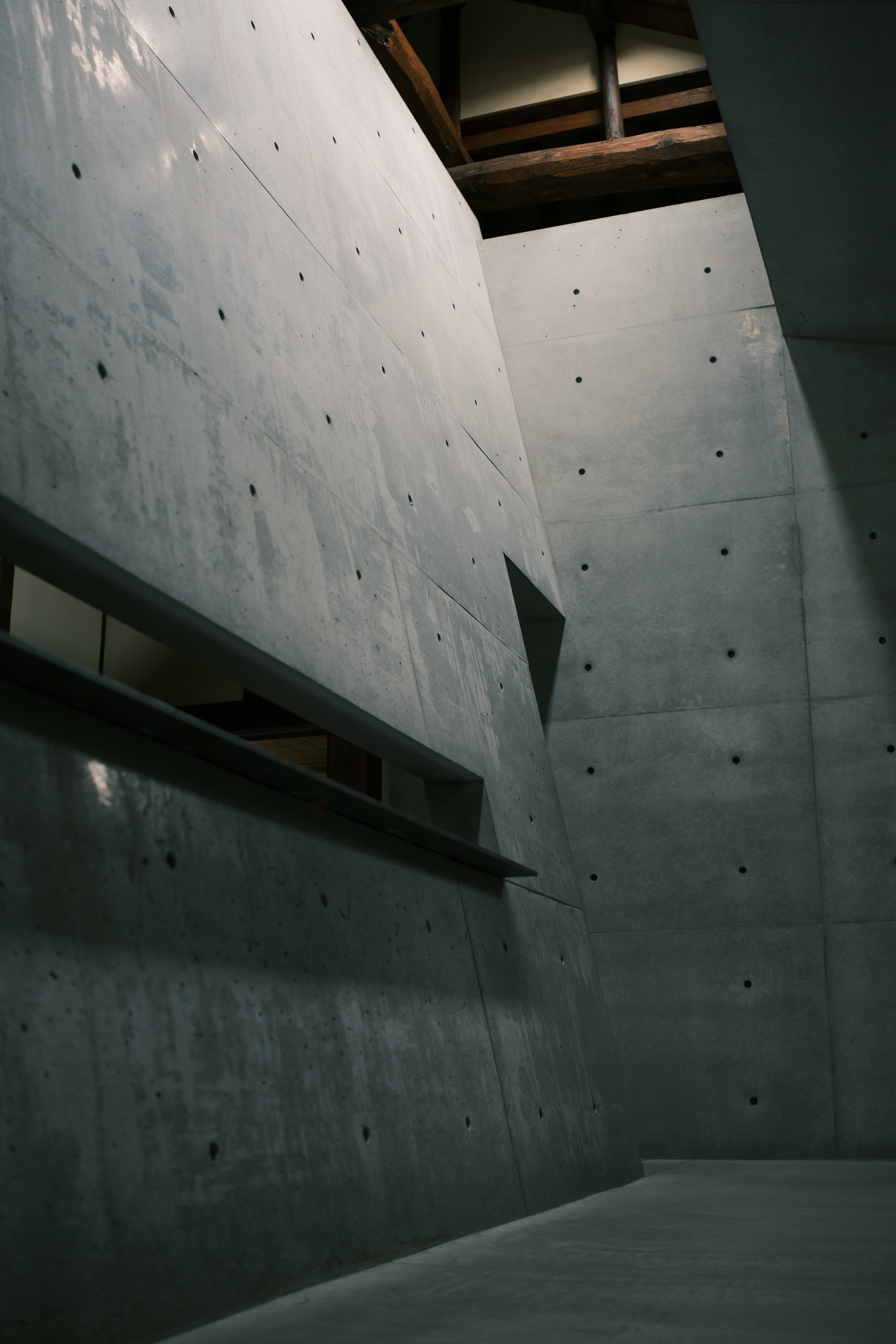 A modern concrete interior features walls.