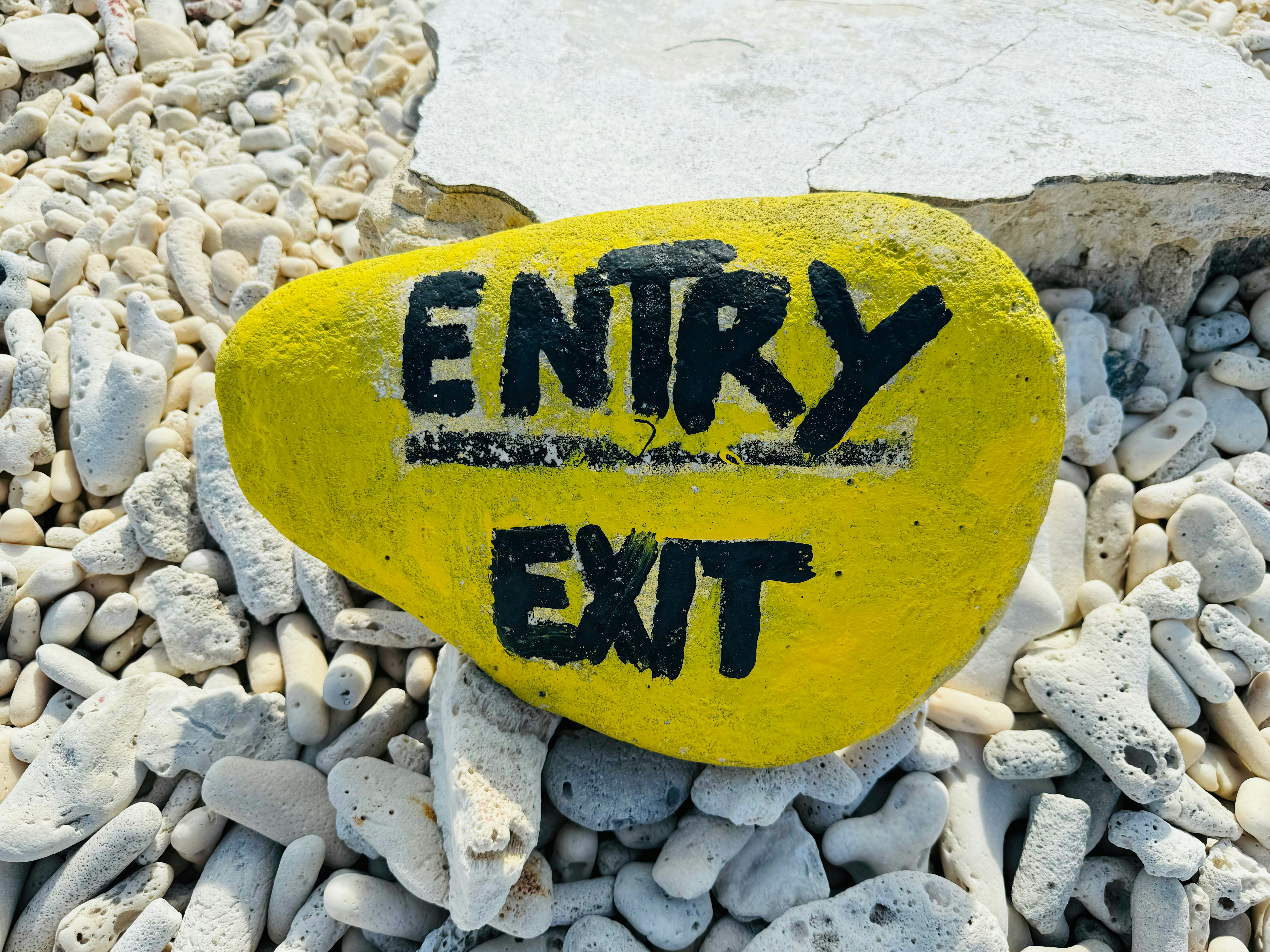 A yellow rock displays the words 