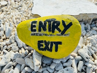 A yellow rock displays the words "entry" and "exit".