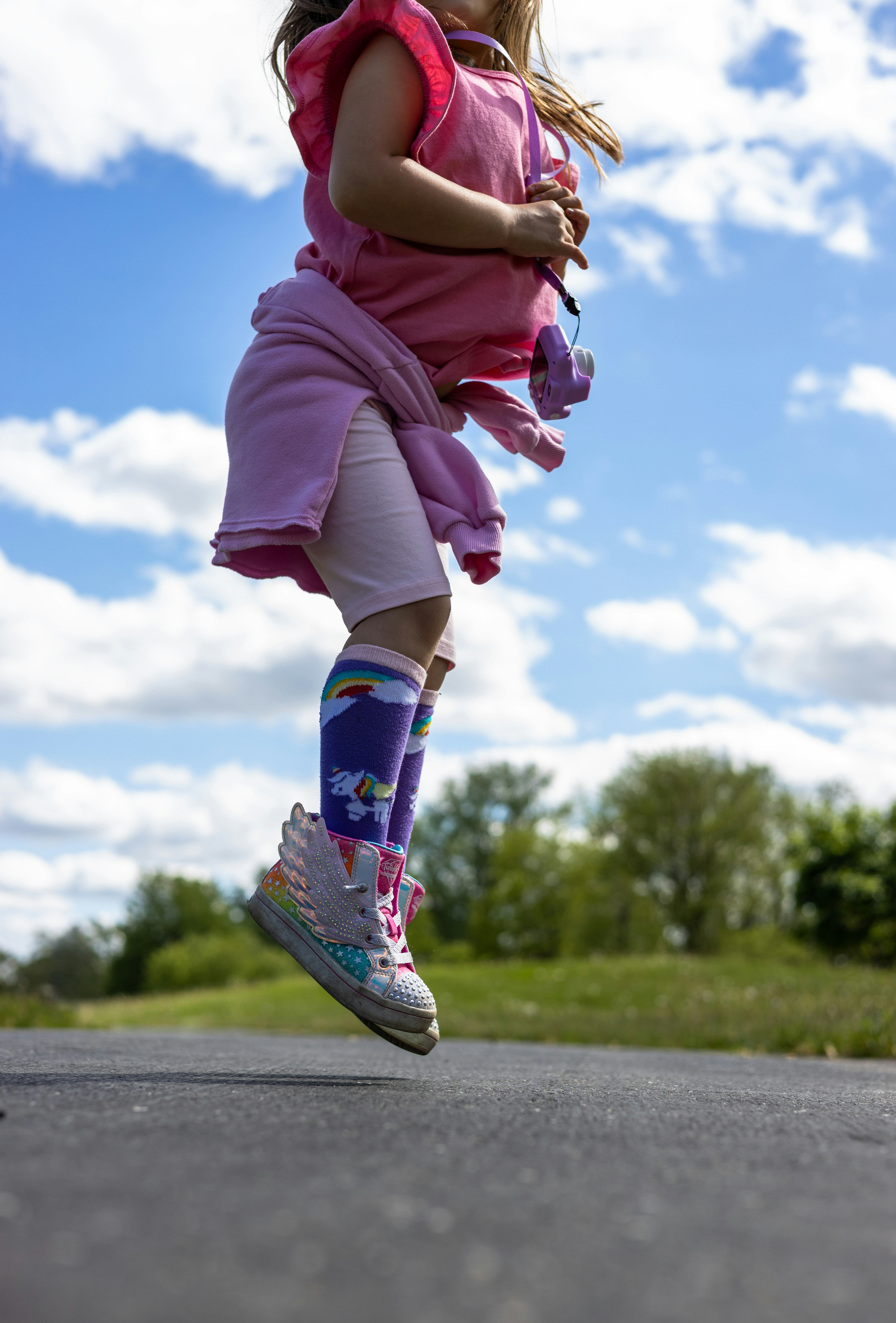 Little girl jumps high in the air.