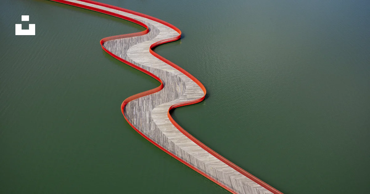 Wind Rises Bridge A winding bridge curves over the water. photo – Free Structure Image on ...