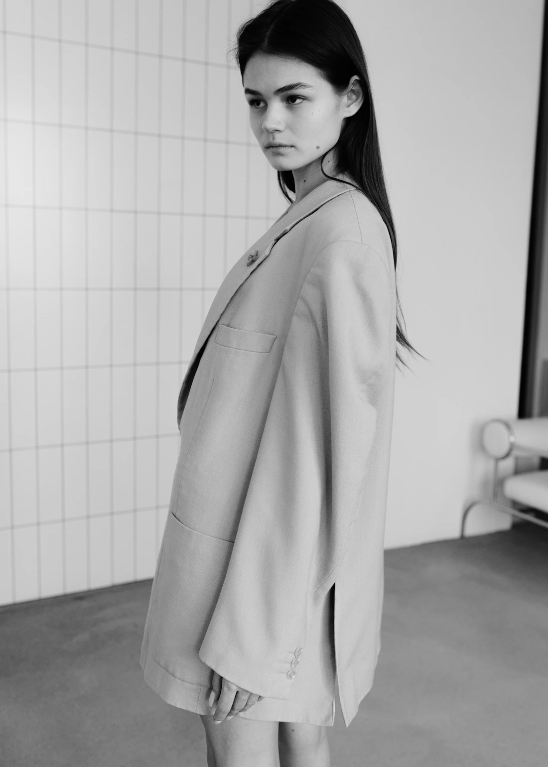Brunette fashion model in a monochrome neutral tailored look