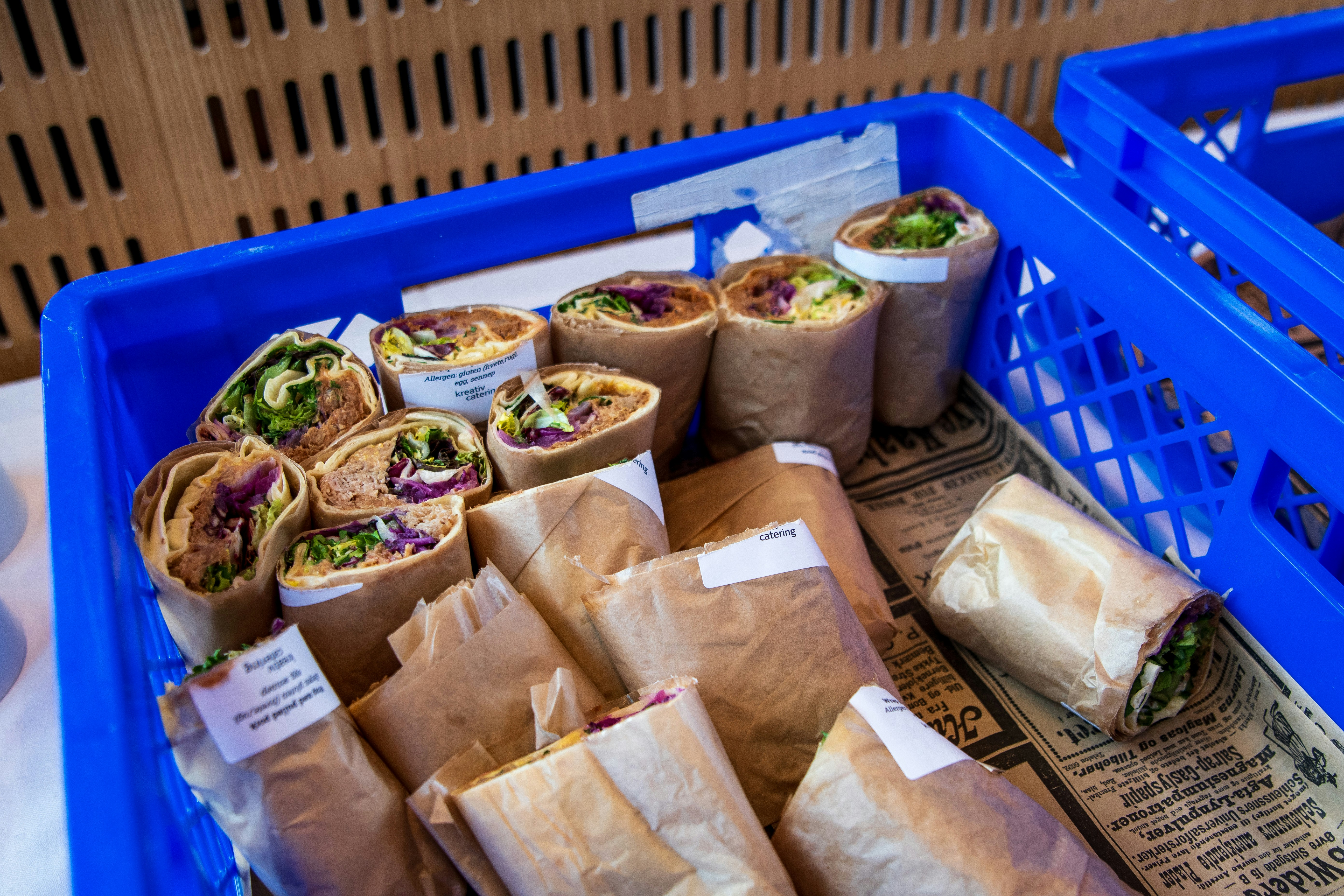 Wraps, neatly arranged in a blue crate.