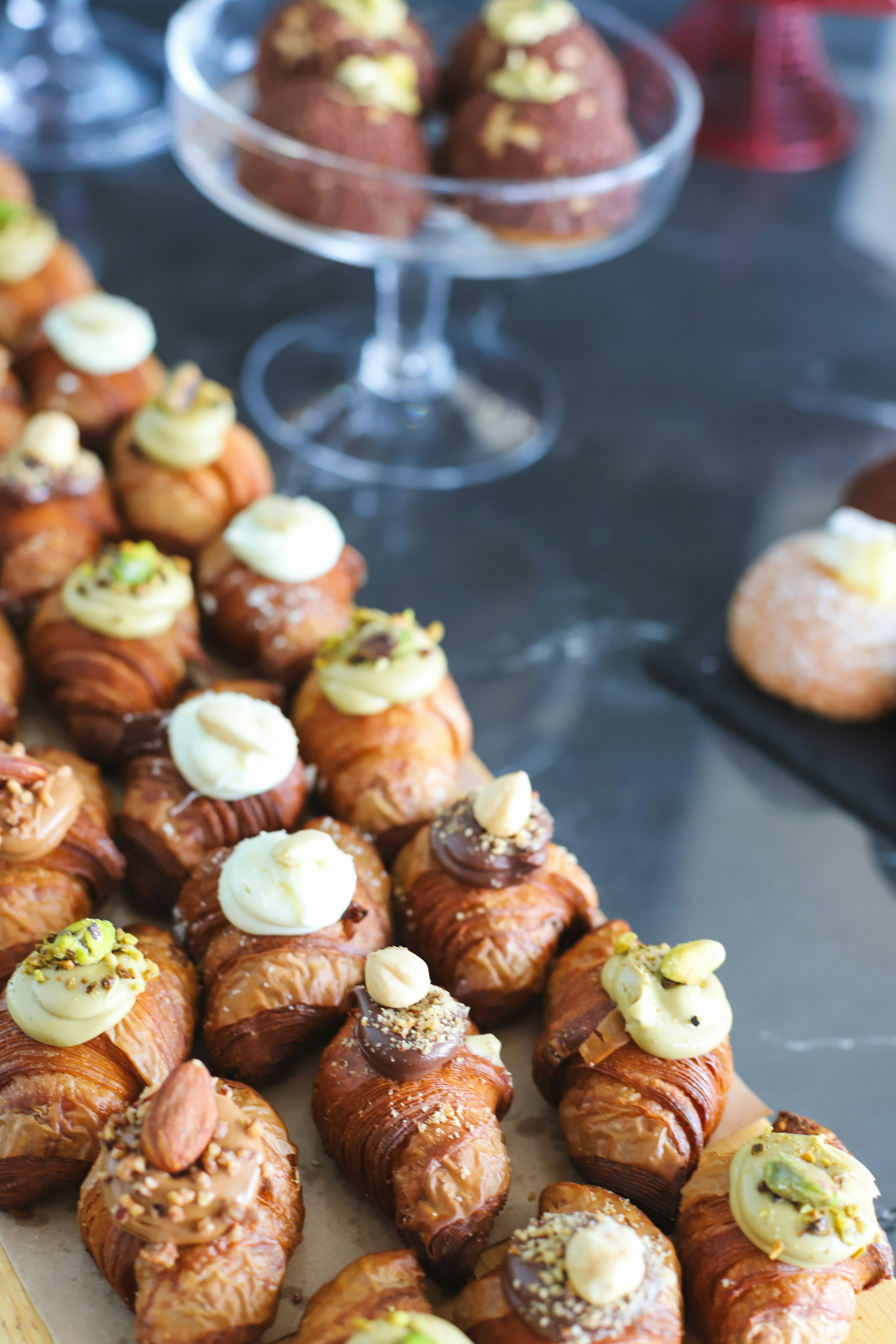 Delicious mini pastries are displayed on a table.