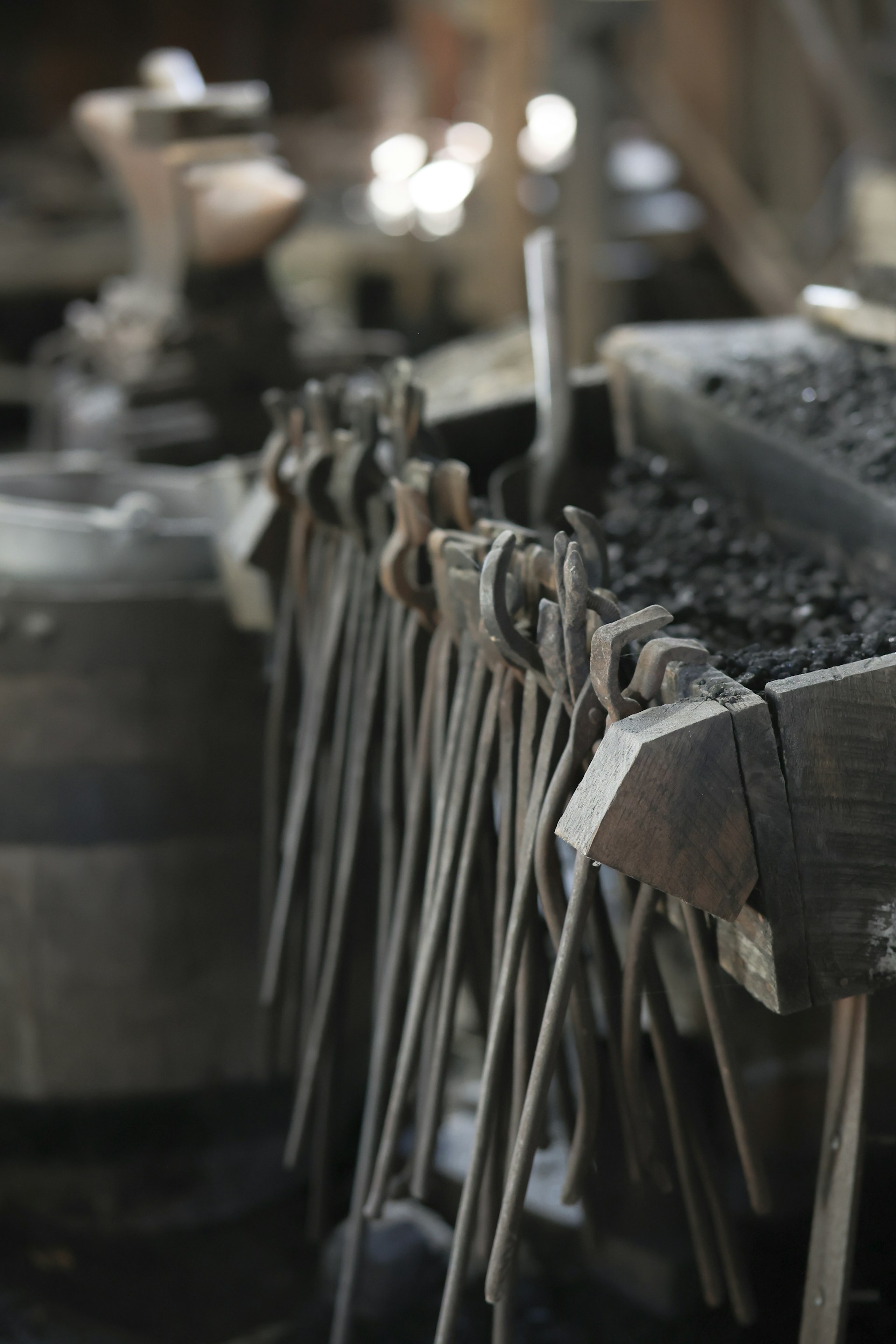 Blacksmith tools neatly arranged in a workshop.