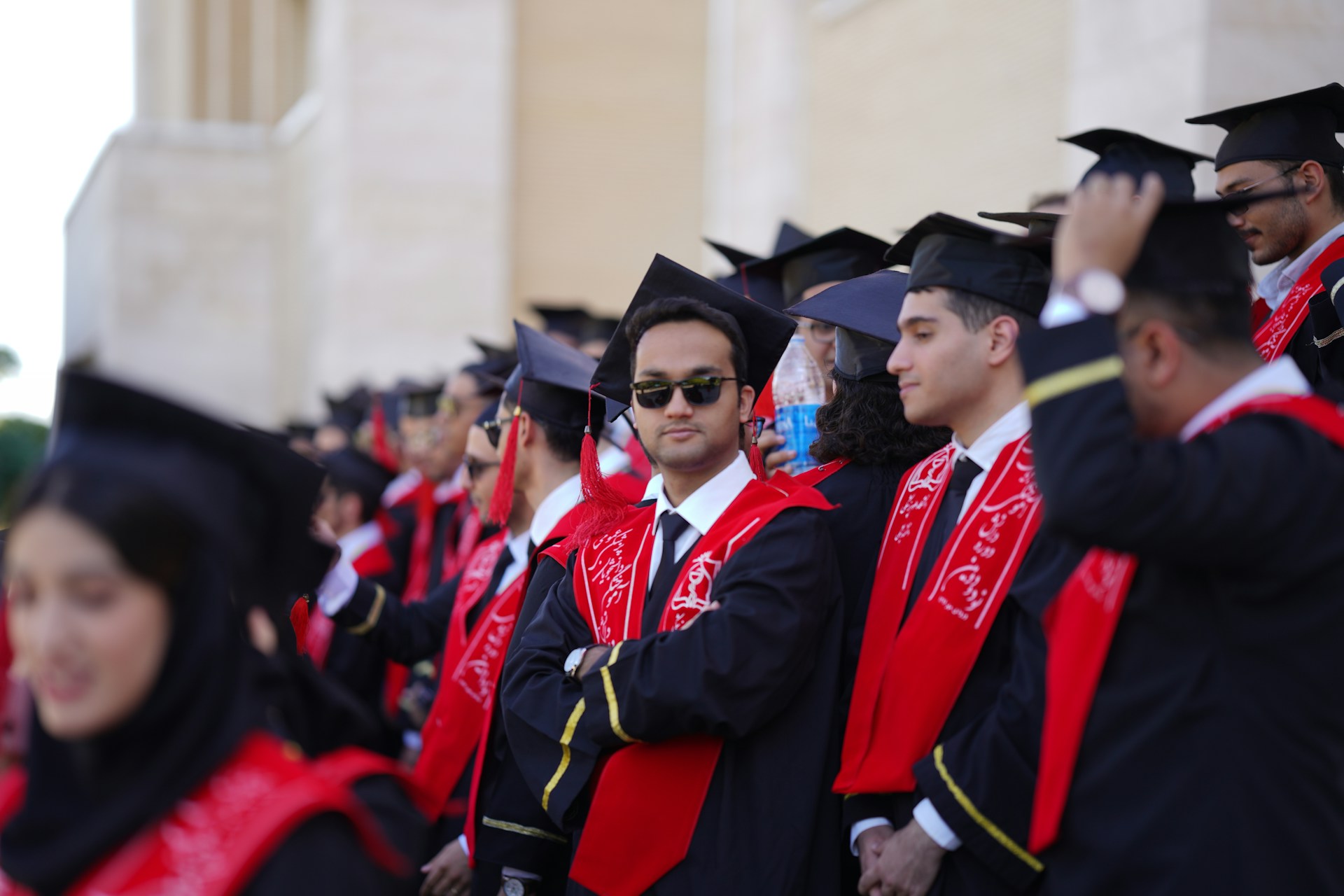 Graduates stand proudly, ready for their ceremony.