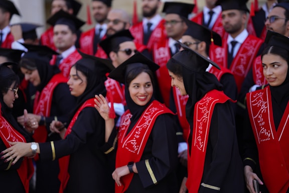 Graduates celebrate with caps and gowns.