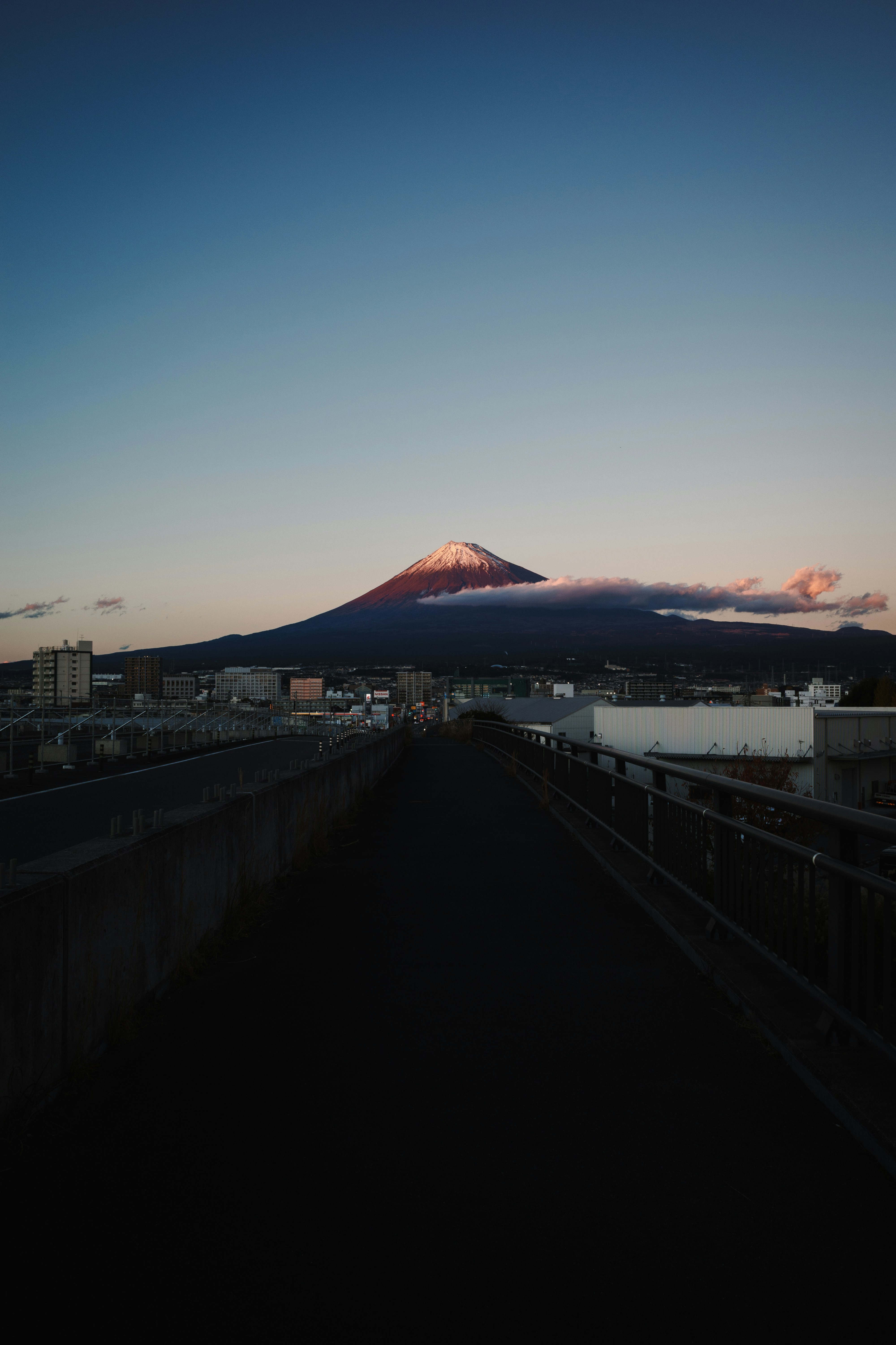 A road leads to mount fuji at dusk.