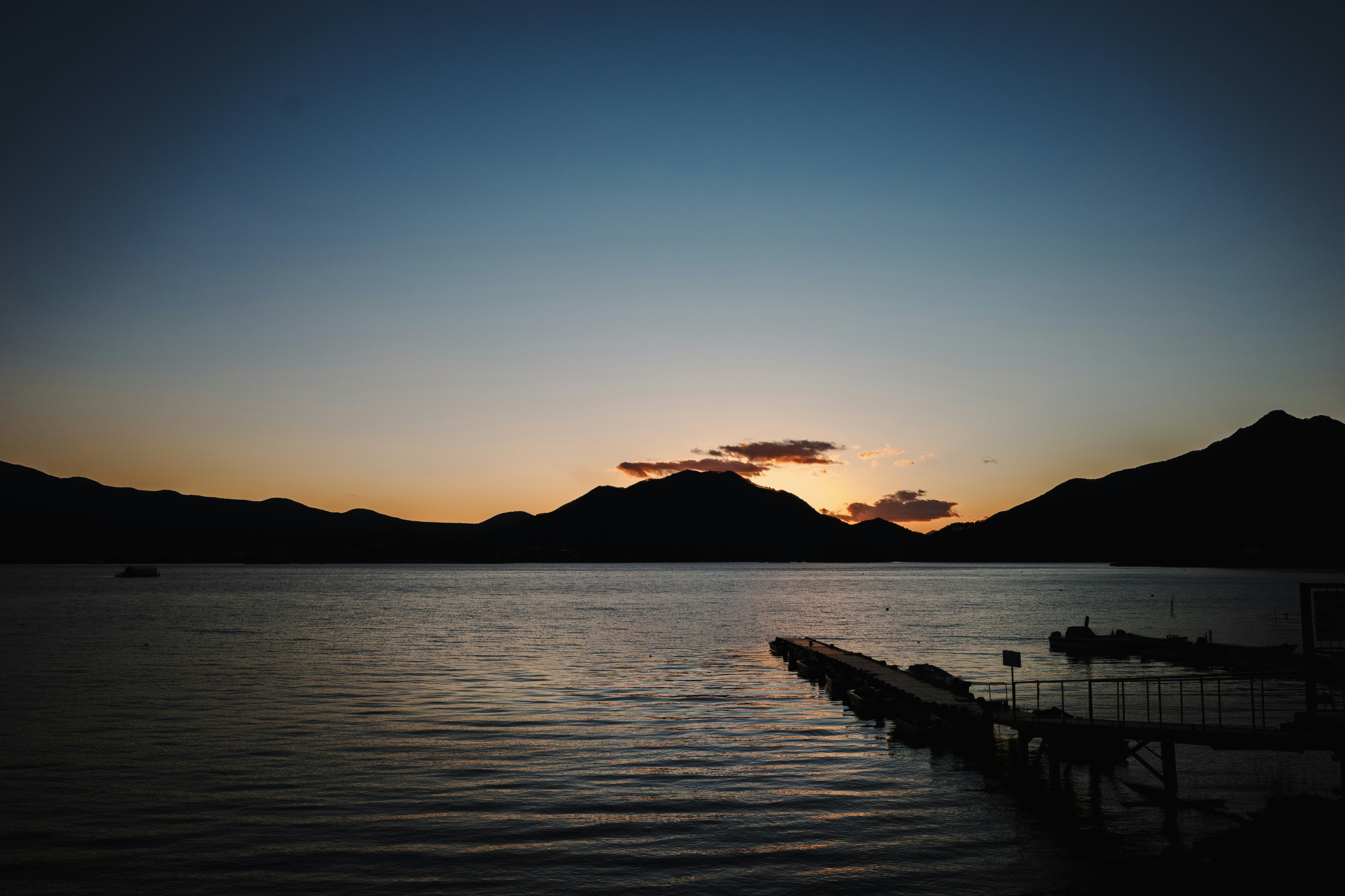 Sunset over the lake with mountains.