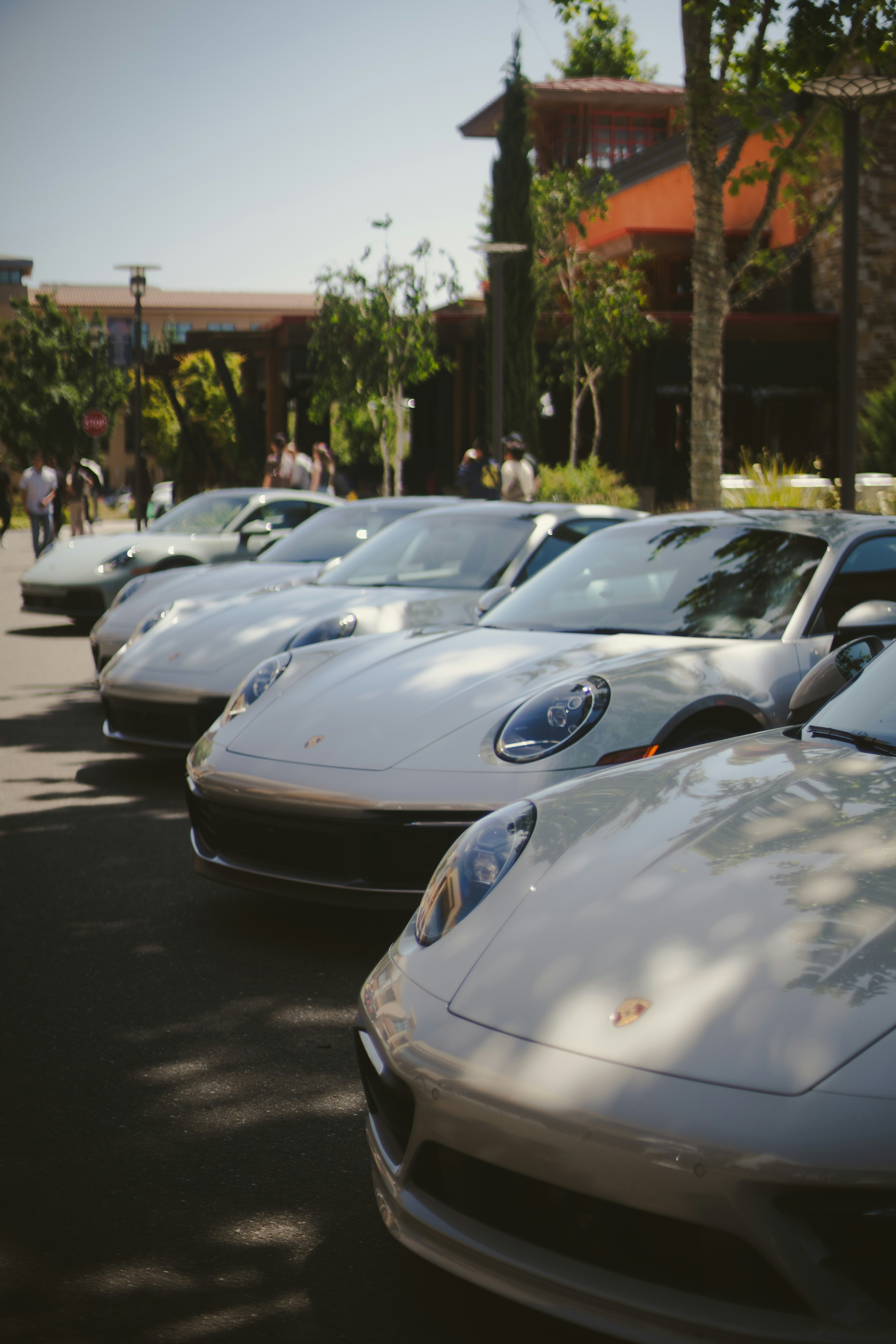 Several shiny porsches are parked in a row.