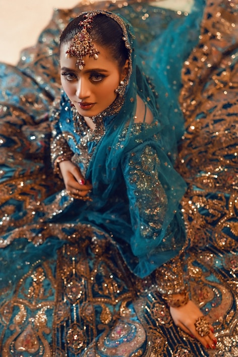 A beautiful woman wears a stunning, embellished dress.