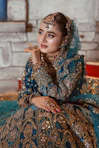 A beautiful bride poses in elaborate wedding attire.