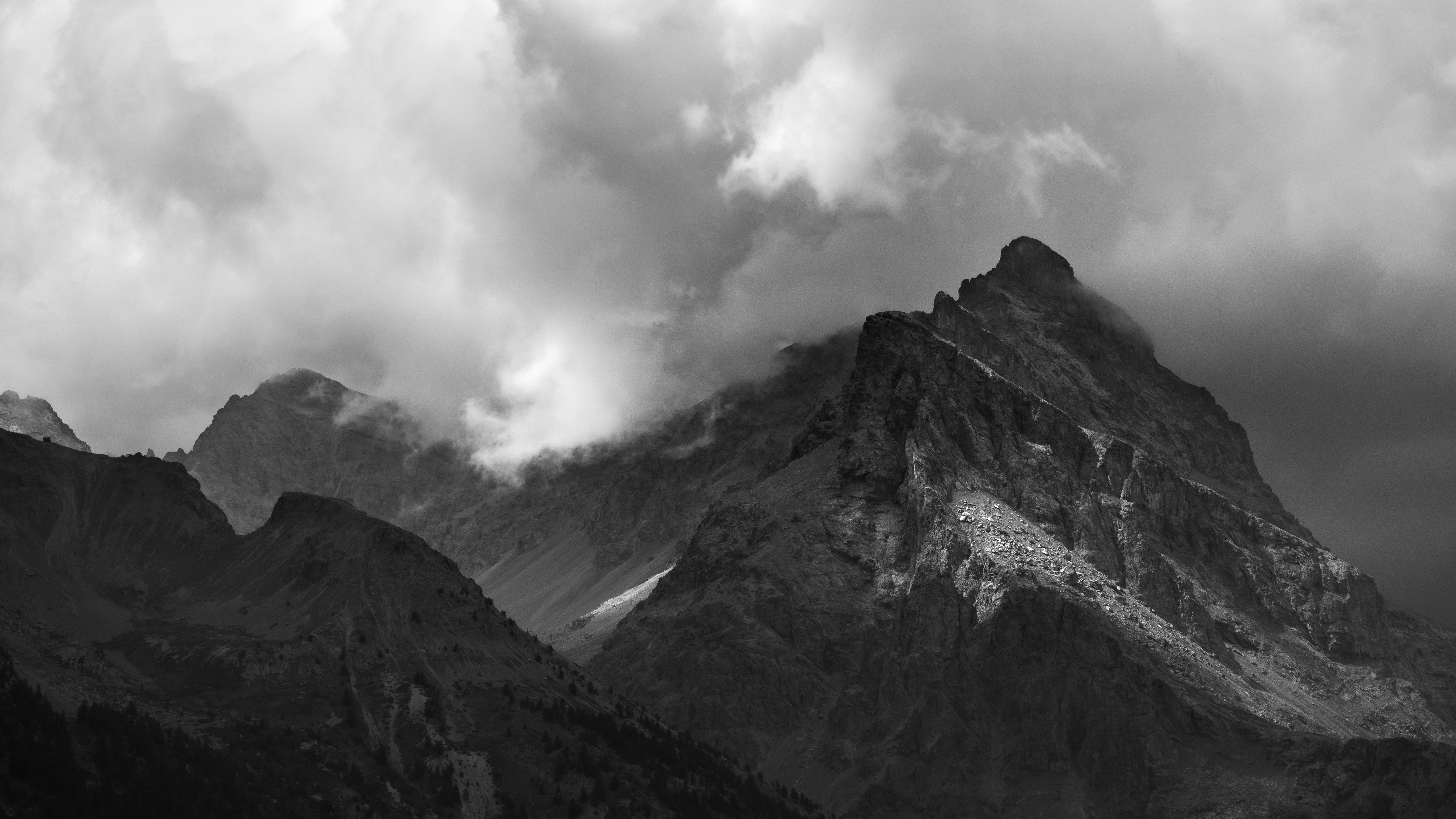 Mountains rise majestically against a cloudy sky.