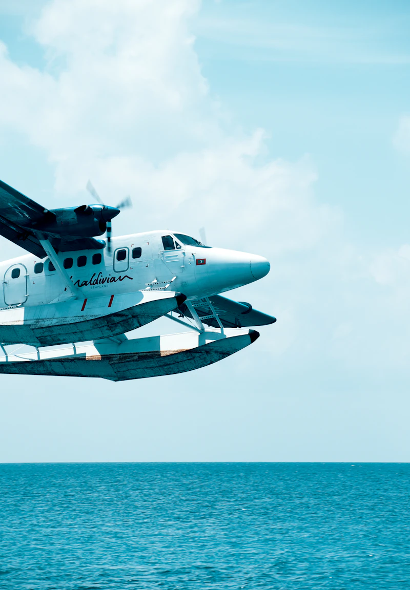 Seaplane flying over clear blue ocean