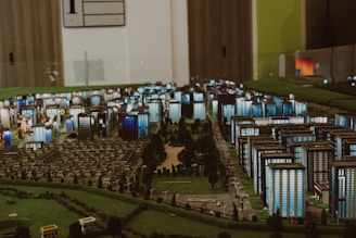 Miniature city model with buildings and trees.