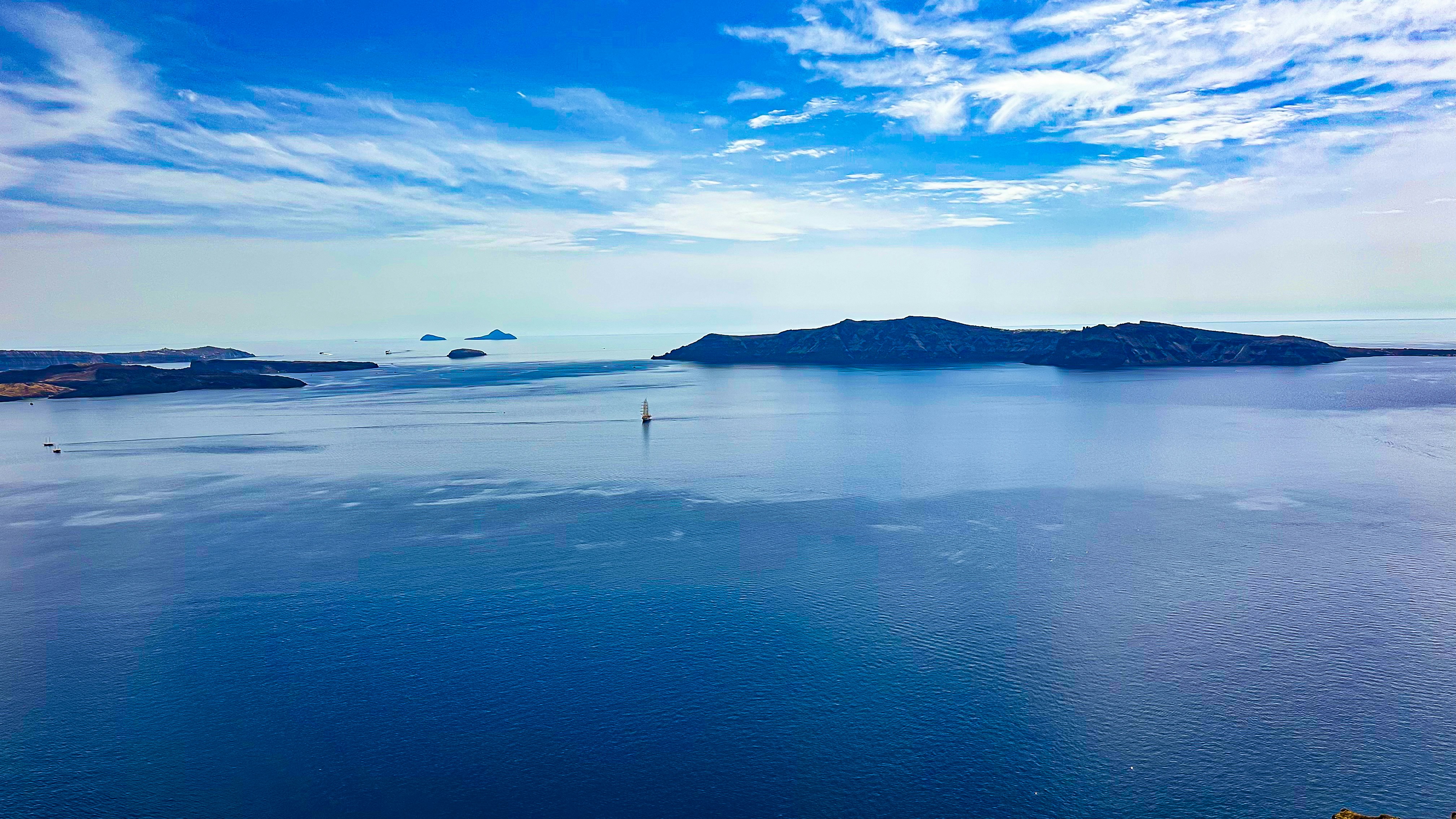 Blue sea stretches towards a distant island.