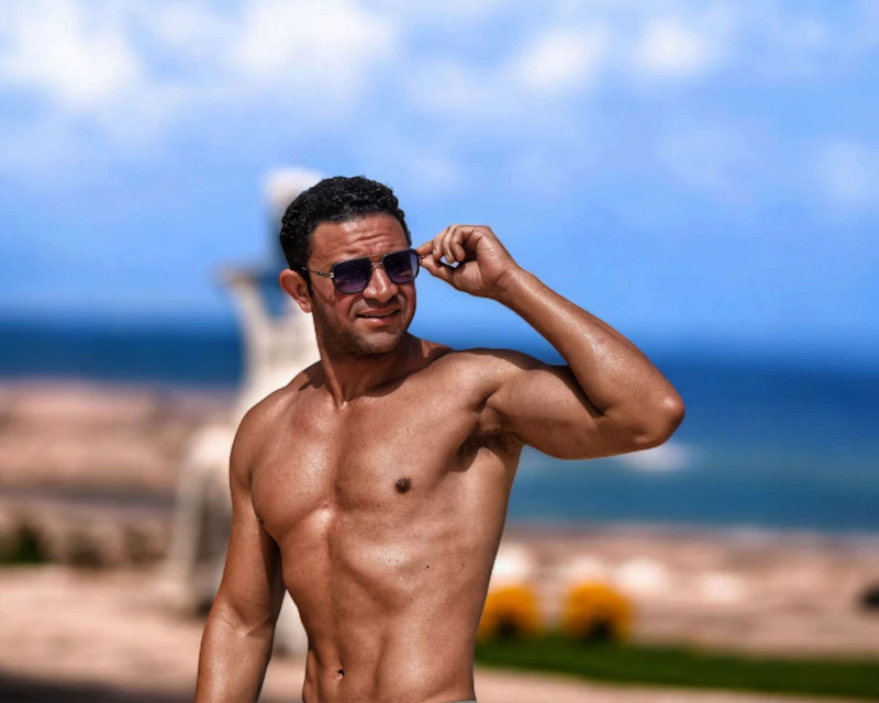 Muscular Indian man outdoors wearing sunglasses