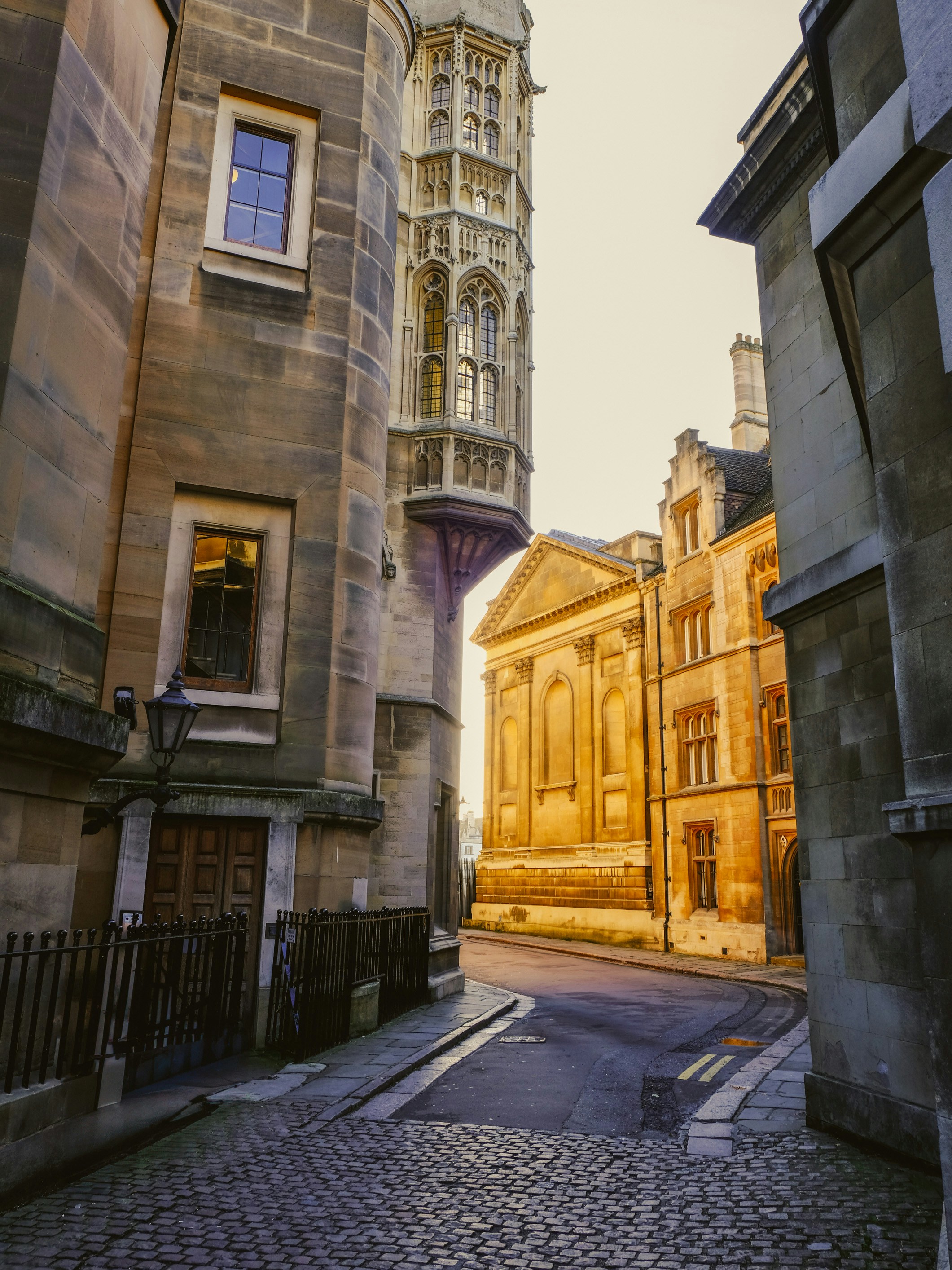 A narrow street leads between old stone buildings.