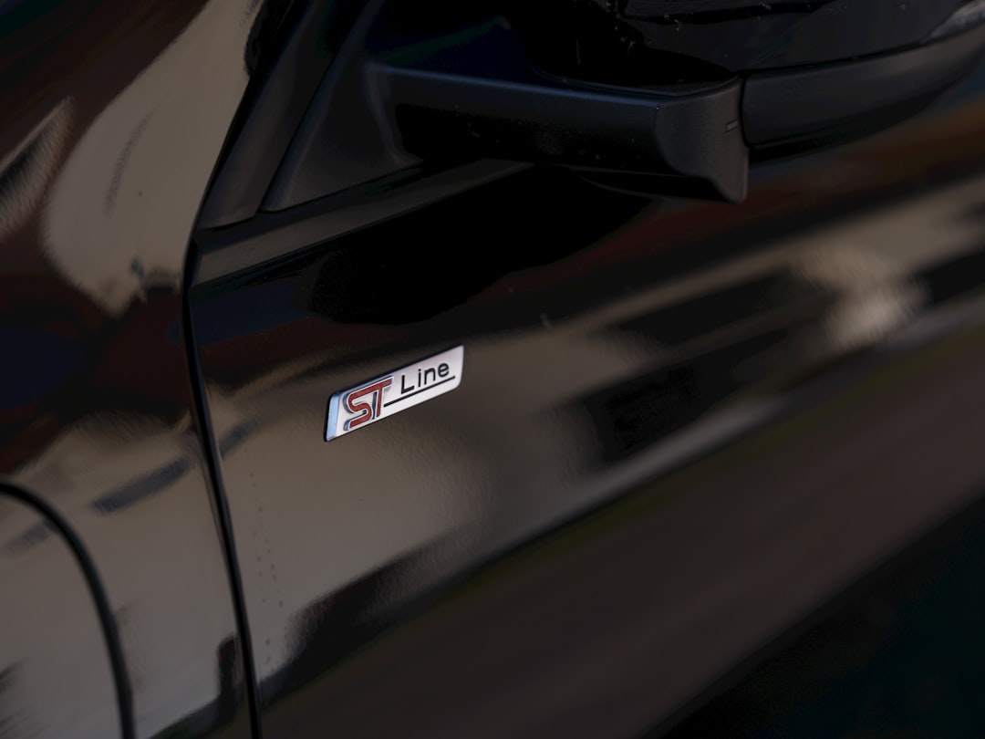 An st line badge is shown on a black car., Ford ST-Line logo