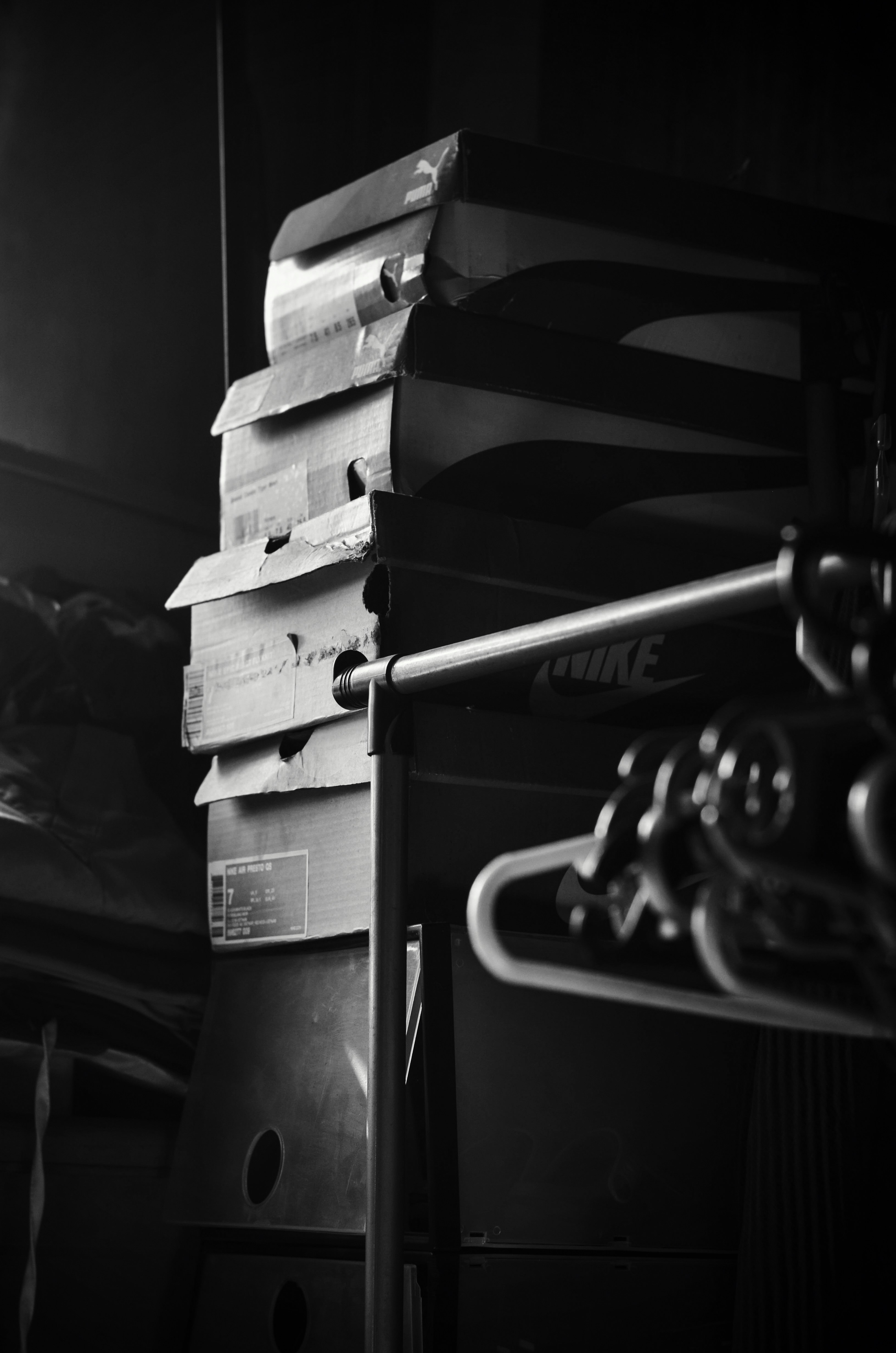 Boxes stacked next to a nike hanging rack.