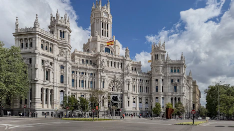 A large, beautiful building stands on a street.