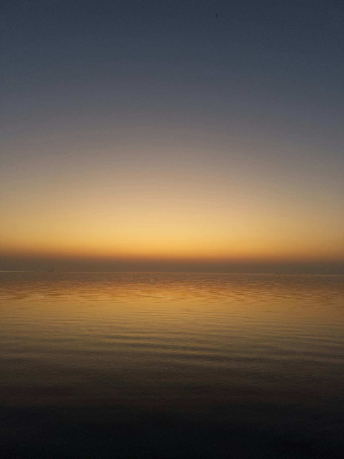 Ruhiger Sonnenaufgang über stillem Wasser als Symbol für Beruhigung nach Unruhe