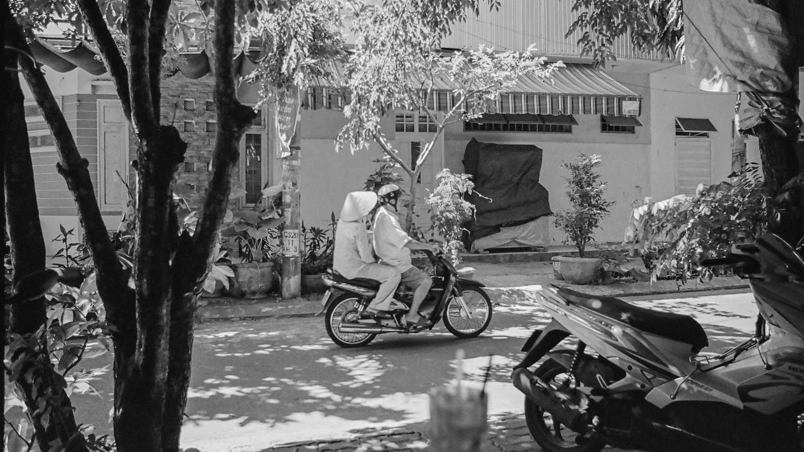 A delivery rider on a scooter in a city street
