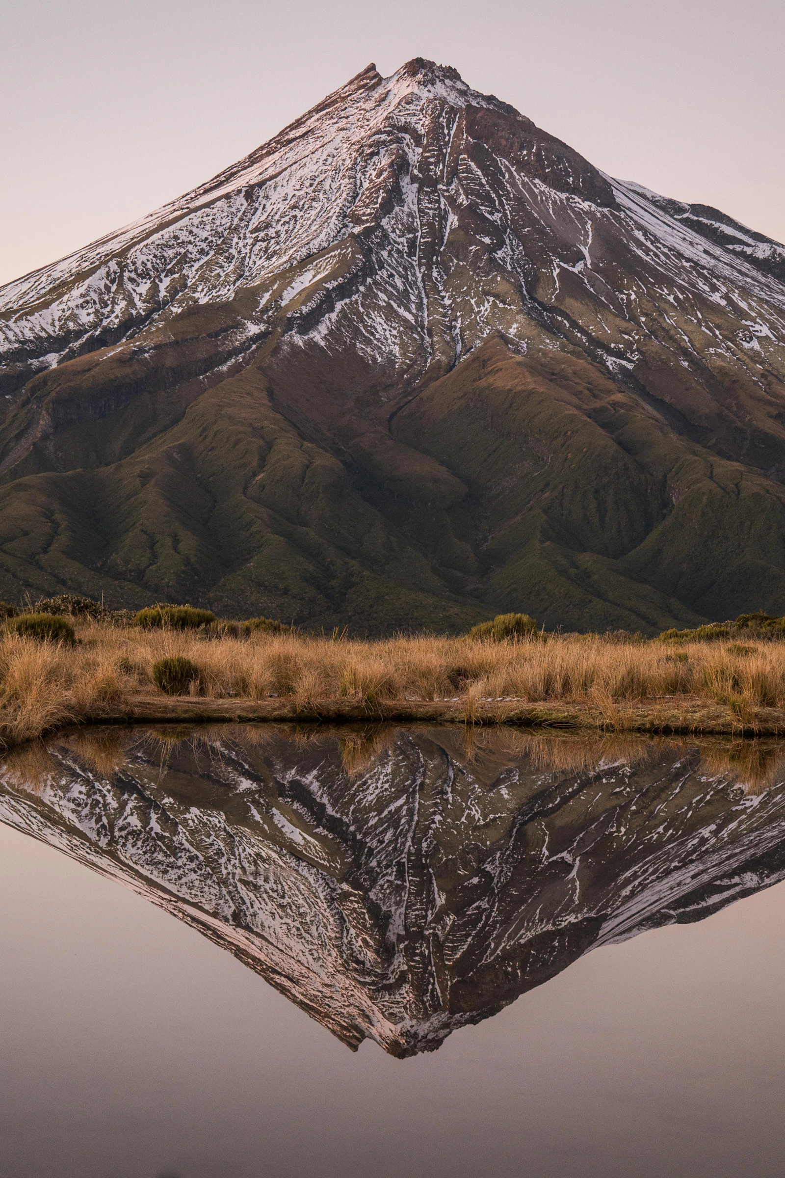 Snow-covered Mt Taranaki reflected in still water